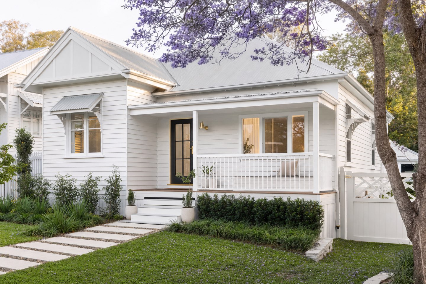 A fresh white weatherboard home in a leafy Brisbane suburb, morning light