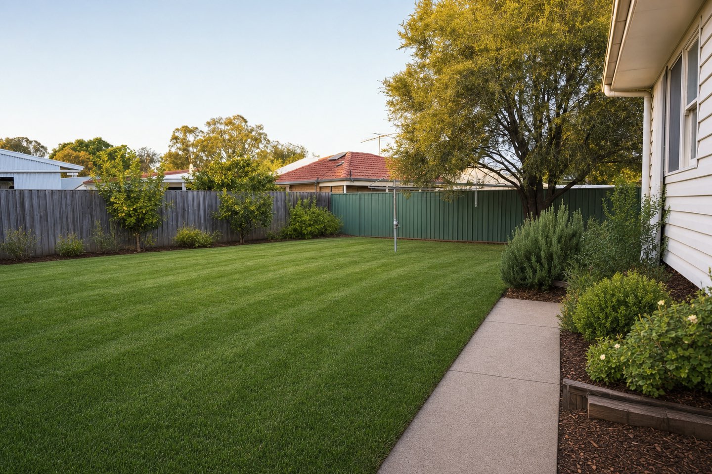 The same backyard lush, mowed and edged after a season on a plan