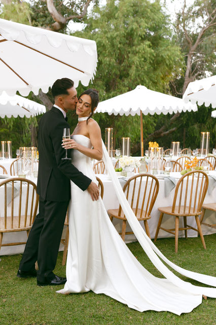 A couple toasting at their styled wedding reception