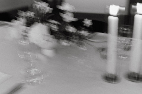 Close-up of a candle-lit floral tablescape
