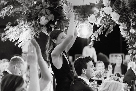 Guests celebrating at a Honeybloom-styled wedding reception