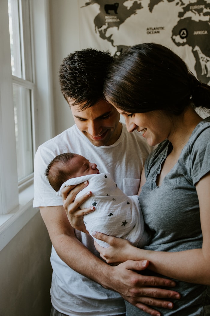 Parents cradling their newborn